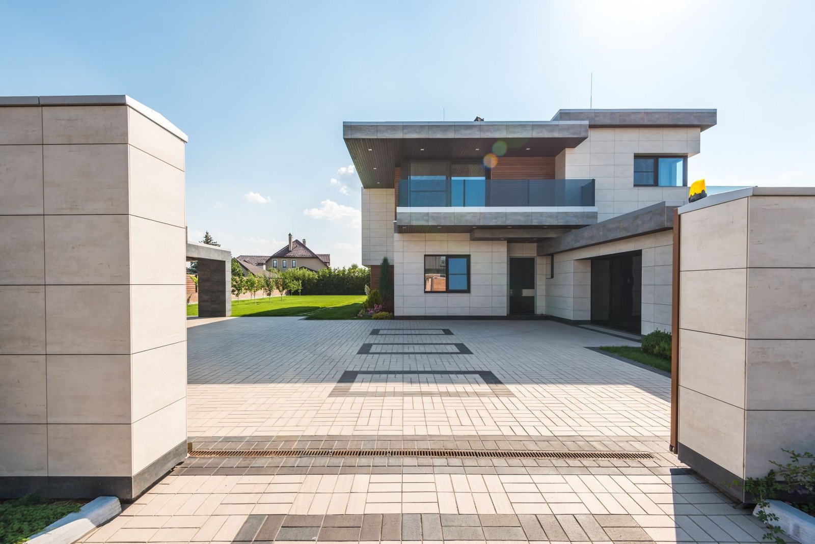 Contemporary two-story home with paved access and surrounding garden
