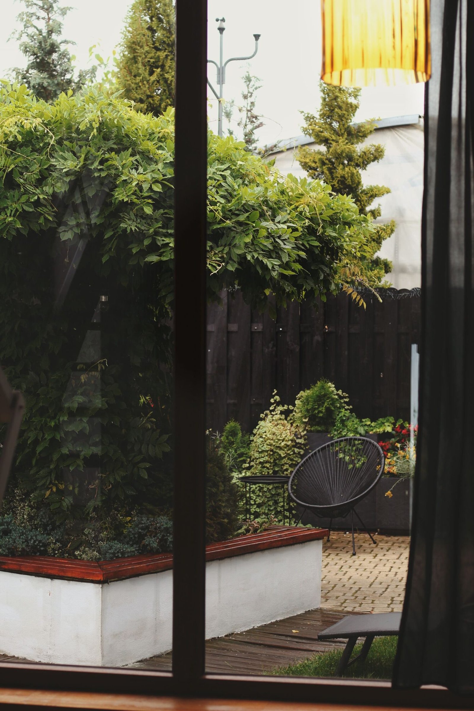 Garden seating area viewed through a glass door