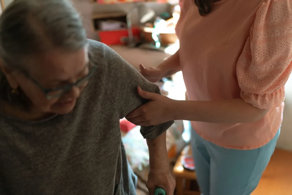 Caregiver supporting an older adult at home