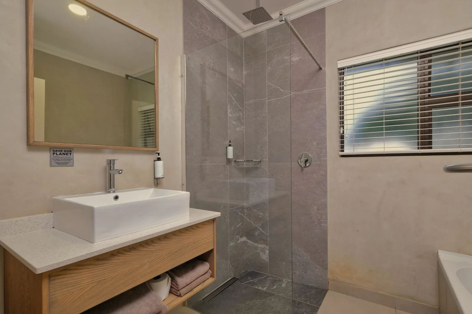 Modern walk-in shower showing a barrier-free bathroom design idea