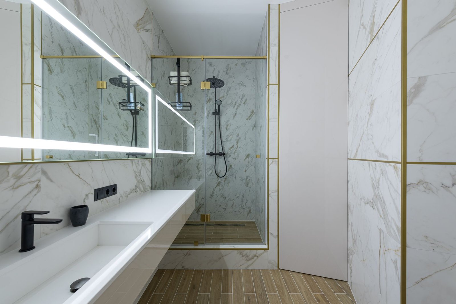 Bathroom with a long vanity and glass-enclosed shower.