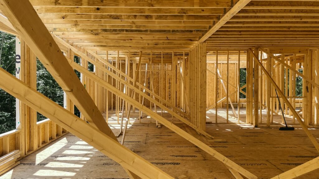 Timber wall framing and ceiling joists inside a home under construction