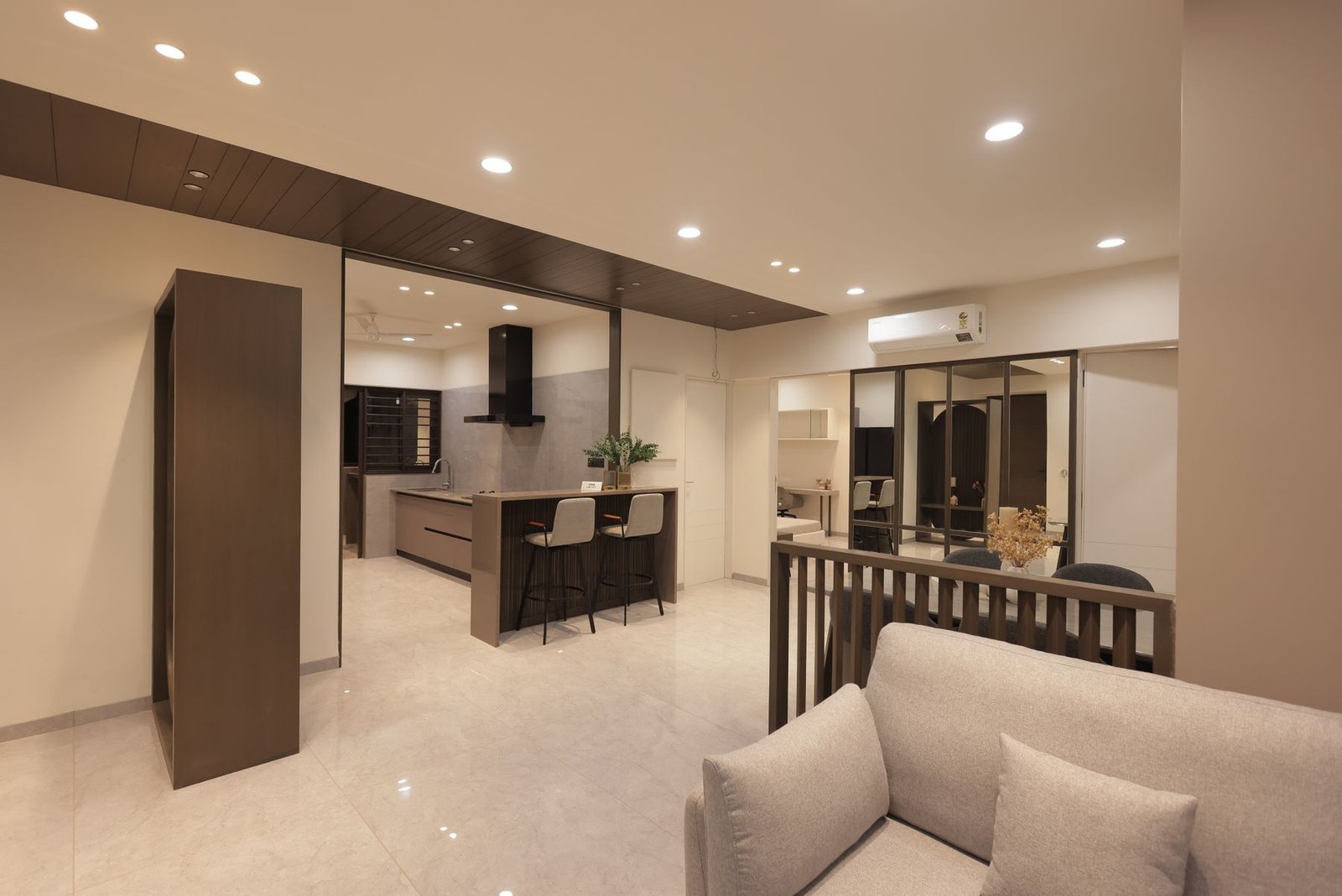 Living area beside a compact kitchen, room divider and mirrored storage