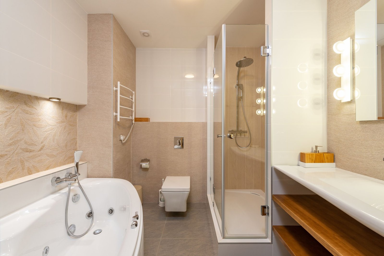 Bathroom with a bathtub, toilet, glass shower and wooden vanity shelves