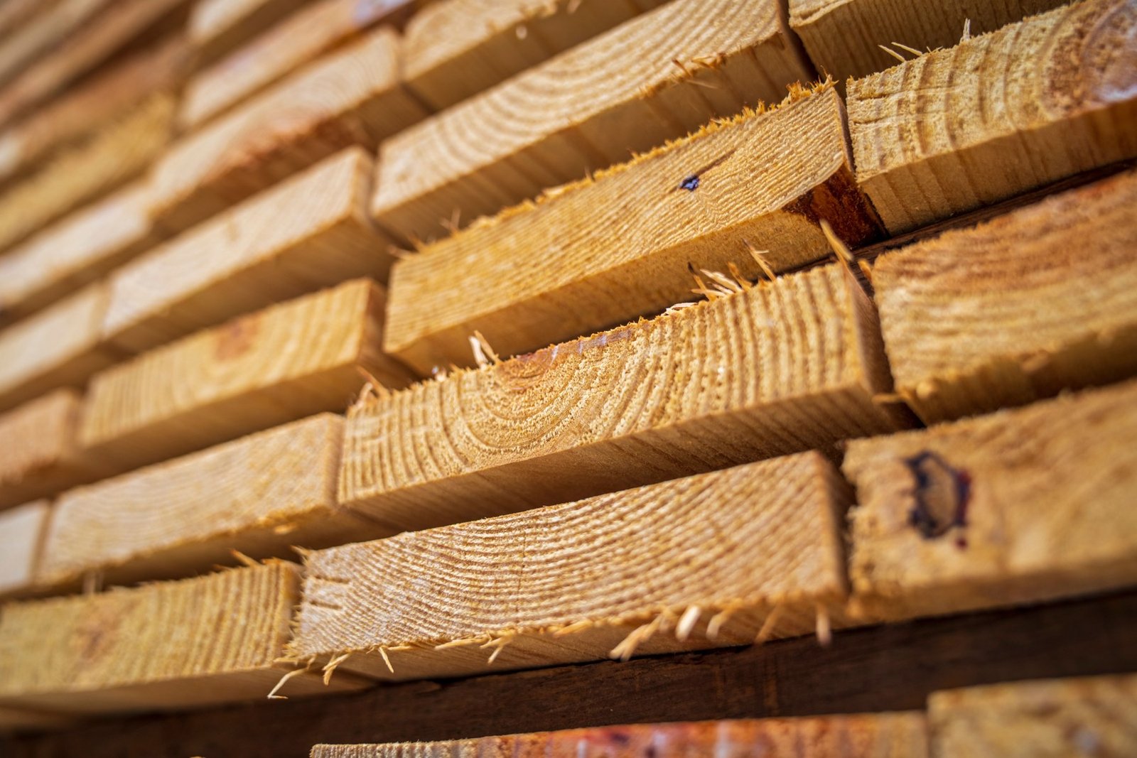 Close-up of stacked rough-sawn wooden boards