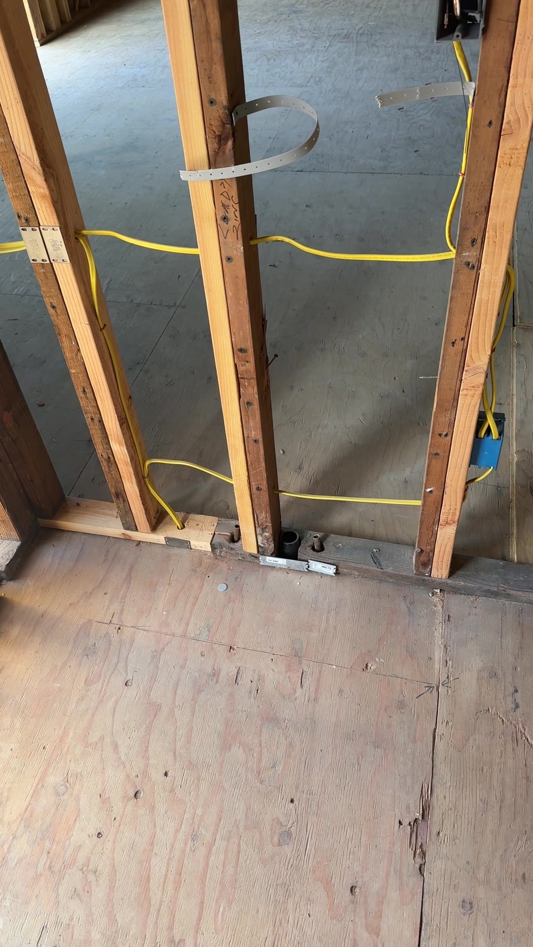 Electrical wiring, boxes and metal protection plates within exposed wood-stud framing